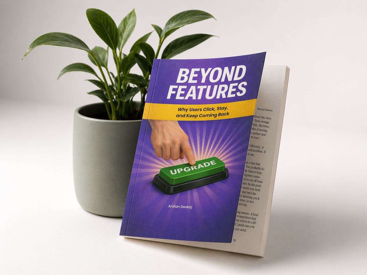 Beyond Features by Ardian Deskaj, the book photographed beside a plant